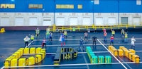 a group of people standing on a concrete floor