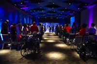 a wedding ceremony in a room with people in wheelchairs