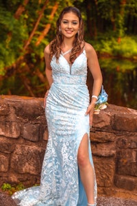 a young woman in a blue dress posing for a photo